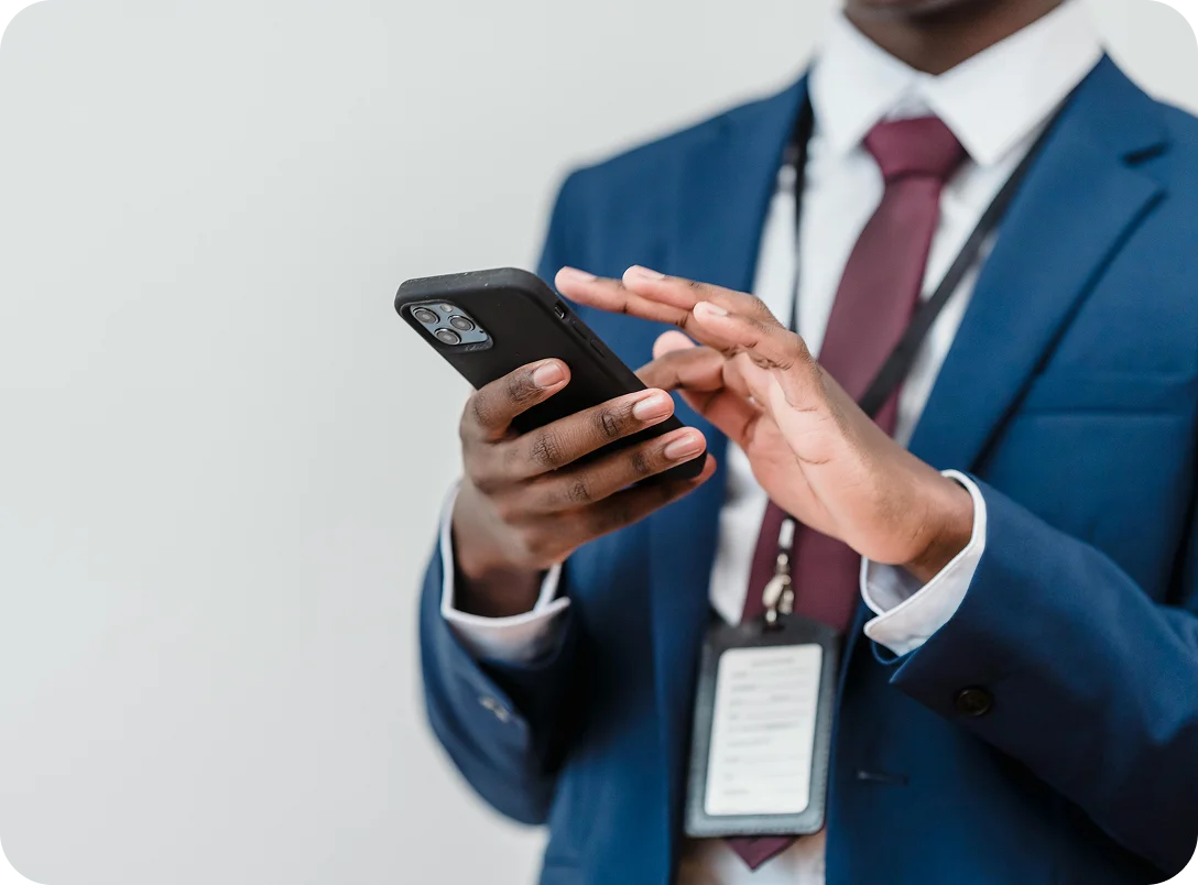A man in a suit using his phone